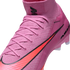 Close-up of a pink Nike soccer cleat featuring an orange swoosh and a high-top Flyknit collar.