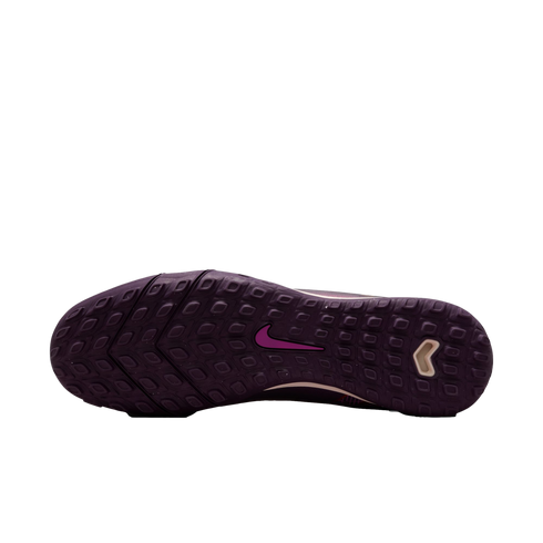 Dark purple Nike turf soccer shoe outsole with rectangular traction studs and a pink swoosh logo.