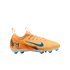 An orange Nike Air Zoom soccer cleat with teal accents and 'KM' logo, shown in profile against a black background.