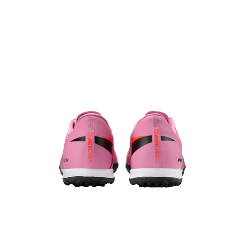 Rear view of a pair of pink Nike Mercurial soccer turf shoes against a solid black background.