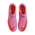 A top-down view of a pair of pink Nike Mercurial soccer cleats with bright orange Nike swooshes and orange interiors, centered on a solid black background.