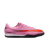 Profile view of a pink Nike Air Zoom turf soccer shoe with a large red swoosh, white midsole, and black outsole.