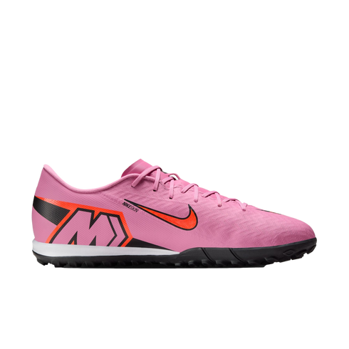 Side profile of a pink Nike Mercurial soccer shoe with orange accents and a black turf sole against a solid black background.