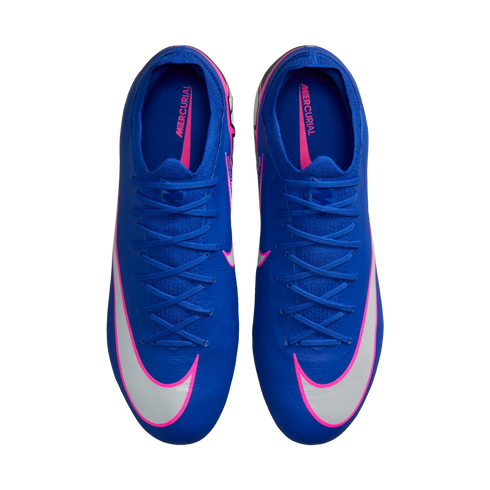 Top-down view of blue Nike Mercurial soccer cleats with white swooshes outlined in pink, set against a black background.