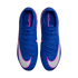 Top-down view of blue Nike Mercurial soccer cleats with white swooshes outlined in pink, set against a black background.