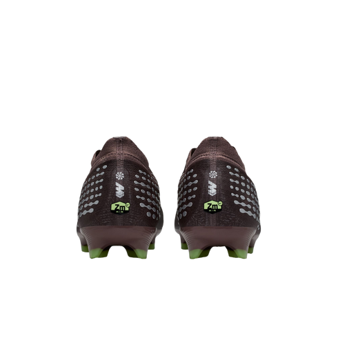 Rear view of two dark maroon soccer cleats with silver patterns, neon green "Zm AIR" branding on the heels, and green studs against a black background.