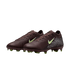 A pair of dark brown Nike soccer cleats with lime green accents and a silver dot pattern on the heel, set against a black background.