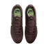 Overhead view of a pair of dark maroon Nike soccer cleats with light green accents and insoles, set against a black background.