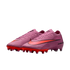 A pair of purple Nike Air Zoom soccer cleats with bright orange Nike swooshes and orange studded soles, set against a solid black background.