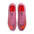 Top-down view of pink Nike Mercurial soccer cleats featuring bright orange Nike swooshes and interior padding, set against a black background.