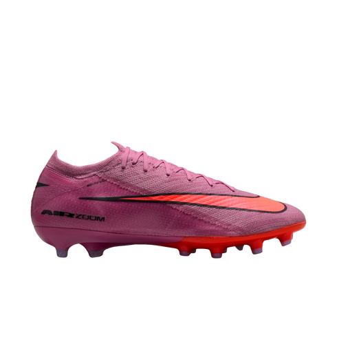 Nike Mercurial football boot in pink with a large orange swoosh and orange studded sole. Features "AIR ZOOM" branding on the side. Set against a black background.