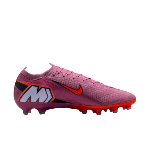 Pink Nike Mercurial soccer cleat with bright orange accents and a large "M" logo on the heel, set against a solid black background.