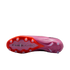 The bottom of a pink and orange soccer cleat against a black background, showing the stud pattern and "AIR ZOOM" branding on the soleplate.