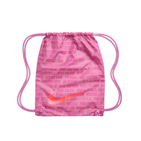 A pink Nike drawstring bag with a repeating pattern of international football terms and a large orange swoosh logo on a black background.