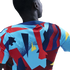 Back view of a person wearing a colorful sports jersey with bold geometric patterns in blue, red, and yellow against a black background.