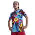 A young girl poses in a vibrant blue, red, and yellow patterned FC Barcelona soccer jersey featuring the Spotify logo against a black background.