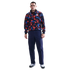 A man wears a red, blue, and black patterned Nike USA tracksuit jacket, navy cargo pants, and white sneakers against a white background.