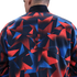 Rear view of a person wearing a jacket with a graphic red, blue, and black geometric pattern. The jacket has a high black collar and visible back seams.