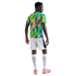 Rear view of a Black man in a colorful patterned jersey, white shorts, long white socks, and pink sneakers against a plain white background.