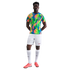 A Black man models a colorful Nike Brazil soccer kit with an abstract pattern jersey, white shorts and socks, and pink cleats against a white background.