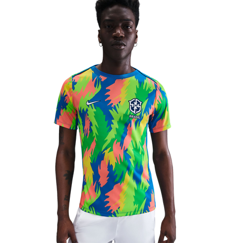 A man in a colorful Nike Brazil soccer jersey with a vibrant jagged pattern and the CBF crest, set against a plain white background.
