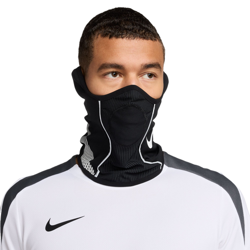 A man wearing a black Nike neck warmer with white accents over his face and a white Nike athletic shirt, set against a solid black background.