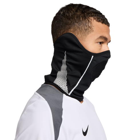 Side profile of a man wearing a black Nike neck warmer over his mouth and nose, paired with a white and grey sports shirt against a black background.