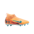 An orange and peach Nike soccer cleat with blue accents, featuring a laceless design, high-top collar, and "KM" logo on the heel, set against a black background.
