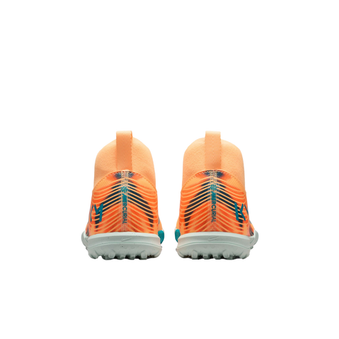 Rear view of two orange Nike Mercurial turf soccer shoes featuring blue accents and KM logos on the heels.