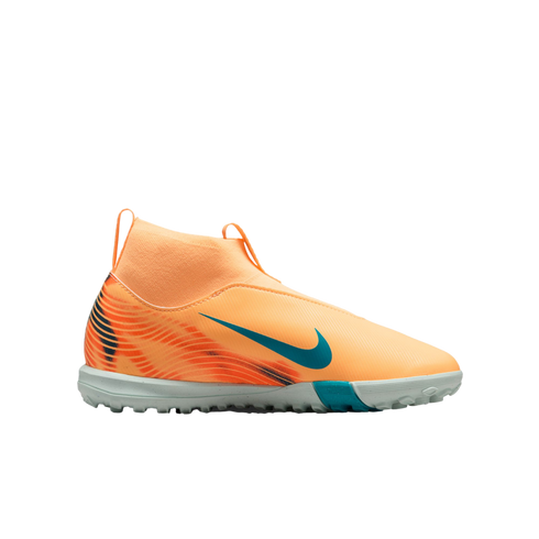 Peach Nike laceless turf soccer shoe with teal accents and a high-top sock-like collar, shown against a solid black background.