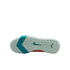 The white textured outsole of a Nike shoe features a teal chevron pattern and teal swoosh logo against a black background.