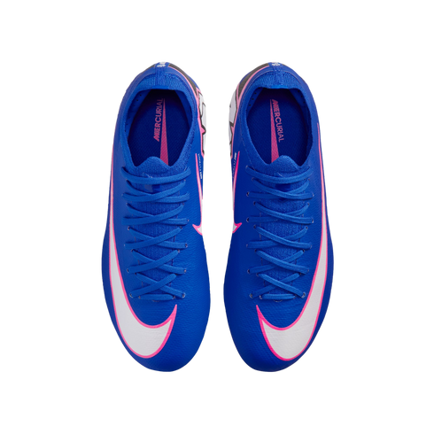 Top-down view of a pair of bright blue Nike Mercurial soccer cleats with large white swooshes outlined in pink, isolated on a black background.