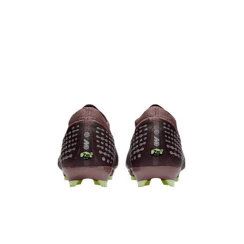 Rear view of two burgundy Nike soccer cleats with silver patterns and lime green accents against a black background.