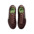 Overhead view of deep burgundy Nike soccer cleats with pale green accents and "KM" branding, set against a black background.