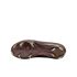 Bottom view of a Nike soccer cleat featuring a metallic brown soleplate with lime green blade-shaped studs, set against a solid black background.