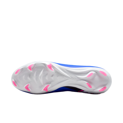 Underside of a Nike soccer cleat featuring a white soleplate with pink chevron-shaped studs, set against a solid black background.