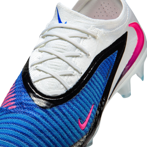 Close-up of a Nike Phantom GX soccer boot featuring a white knit collar, textured blue upper, and a pink swoosh.