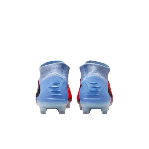 Rear view of light blue and red soccer cleats with high-top collars and clear studs, against a black background.