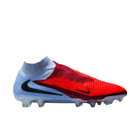 Side profile of a Nike soccer cleat featuring a red and light blue design, black swooshes, and a high-top collar, shown against a black background.