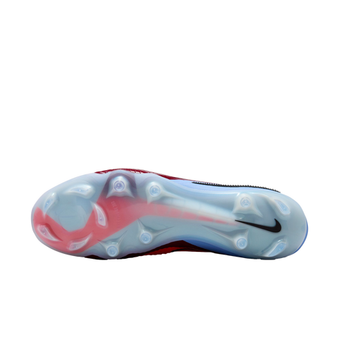 Bottom view of a light blue and red Nike soccer cleat with translucent traction studs against a black background.