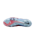 Bottom view of a light blue and red Nike soccer cleat with translucent traction studs against a black background.