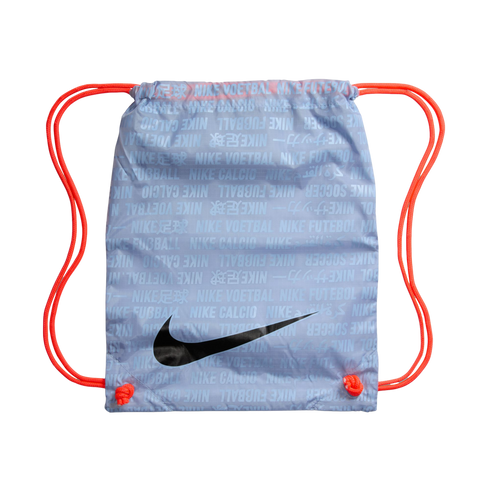 A light blue Nike drawstring bag with orange cords, featuring a large black swoosh and a repeating text pattern of "Nike Soccer" in several languages.