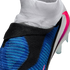 Close-up of a blue, black, and white Nike soccer cleat featuring a textured upper and a knit ankle collar.