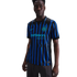 A man models the Inter Milan home jersey featuring black and blue wavy stripes, the Nike swoosh, club crest with two stars, and the Betsson Sport sponsor logo.