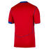 Back view of a bright red short-sleeved sports jersey featuring blue trim on the collar, sleeve cuffs, and side seams against a solid black background.