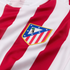 Close-up of a red and white striped football jersey featuring the Atlético Madrid club crest.