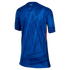 Back view of a blue soccer jersey featuring an abstract tonal graphic pattern, "CFC" on the back neck, and a red and white side stripe.