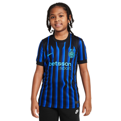 Smiling child with braided hair wearing an Inter Milan blue and black striped soccer jersey with a Betsson logo and Nike swoosh, against a white background.
