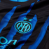 Close-up of a blue and black striped football jersey with the Inter Milan logo and two stars embroidered in light blue.