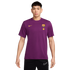 A young man models a purple short-sleeve FC Barcelona t-shirt with gold Nike and Spotify logos, and club crest, paired with black Nike shorts.